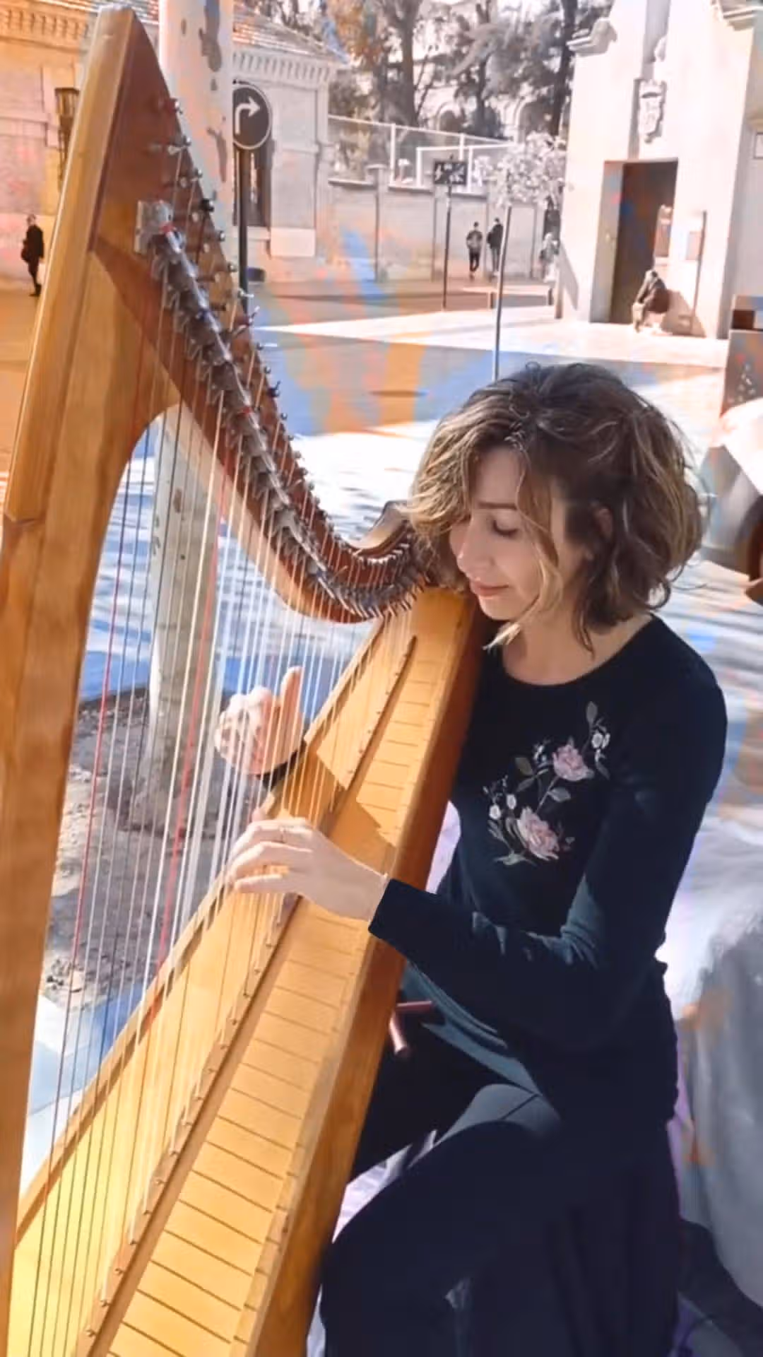 Elena Aker con arpa en entorno natural